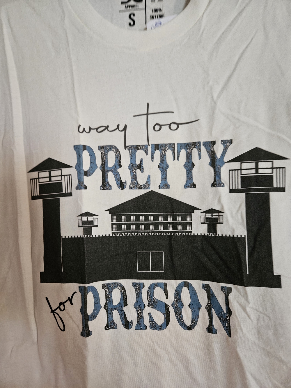 DC White Short Sleeve Tee with Black Prison Graphic and Blue Glitter-Effect Text